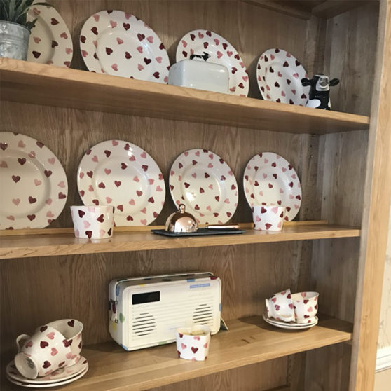 A Welsh dresser adorned with ceramic plates and cups, at Farnham care home, immediately tells dementia residents that they are in the dining room.
