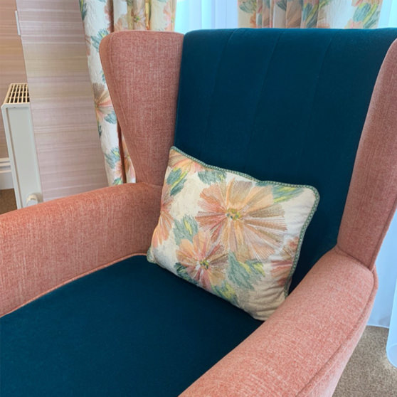 This high back chair in Falkland Grange Care Home in Newbury has deliberately contrasting colours for the seat and the outer area, helping visually impaired residents see where to sit.